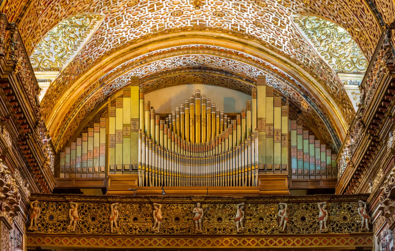 Main nave of the Church of the Society of Jesus (La Iglesia de la Compañía de Jesús), a Jesuit church in Quito, Ecuador. The exterior doesn't give an idea of the beauty of the interior, with a large central nave, which is profusely decorated with gold leaf, gilded plaster and wood carvings, making of it the most ornate church in Quito. The temple is one of the most significant works of Spanish Baroque architecture in America and considered the most beautiful church in Ecuador.