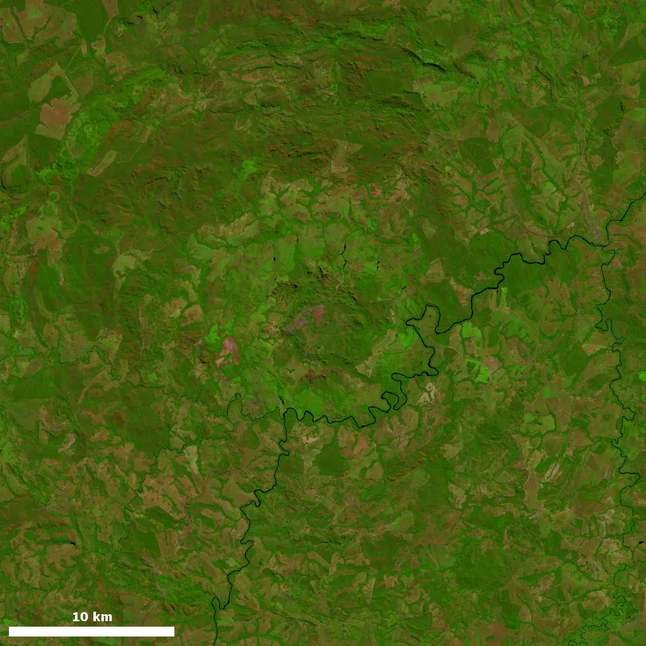 Landsat image of Araguainha crater, southern Brazil. The Araguainha river traverses the image. Brightness and contrast were adjusted from original.