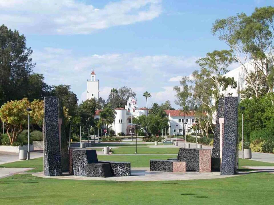 Campanile Mall extends north on Montezuma Mesa through the College Area of San Diego. Public artwork: "100 Years 100 Stones" in foreground. (Hardy Memorial Tower in the distance)