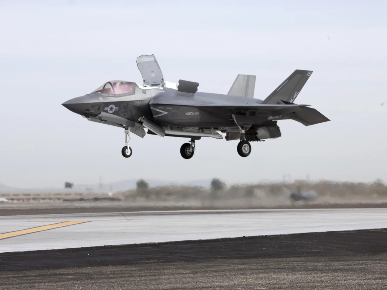A U.S. Marine Corps Lockheed Martin F-35B Lightning II from Marine Fighter Attack Squadron 121 (VMFA-121) conducts a vertical landing on the Marine Corps Air Station Yuma, Arizona (USA), flightline on 21 March 2013. "VK-15", piloted by Maj. Richard Rusnok, an F-35B test pilot, conducted the first short take off, vertical landing outside of a testing environment.