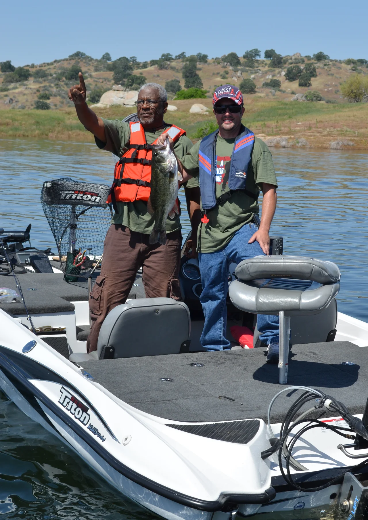 A veteran and a local volunteer showoff their catch during the "Take a Warrior Fishing" event at Eastman Lake, Calif., May 12, 2012. The event was the first of its kind for the U.S. Army Corps of Engineers Sacramento District. (U.S. Army photo by Carlos J. Lazo/Released)