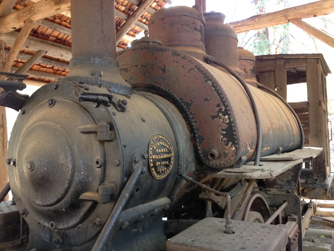 Vital statistics: Gauege 4 feet 8 1/2 inches; Fuel wood or soft coal; boiler diameter 38 inches; Wheel base 72 inches; cylinders 13 inches by 30 inches; diameter of drivers 37 inches; tank capacity 800 gallons; smoke stack diamond; steam pressure 130 pounds; weight 45,000 pounds; built 1884.
This locomotive was nicknamed “GOP” “Get Out and Push” because it derailed quite iften. The locomotive was designed to haul 70 gross tons of car and cargo up a 4% grade. This engine was used in the California redwoods and around Mt Shasta from 1890.