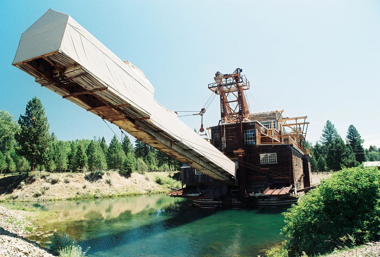 Gold Dredge in Sumpter, OR and they thought that environmental damage would fix itself.  The valley that Sumpter rules over is a barren, craggy maze of tailings.  THis thing went along digging up the creek bed, zig-zagging along its way and dumping rock behind it.  Out of this very ramp in fact. It's been laid up in this park for a few decades now and the only life is a few scraggly trees amongst the stone.  Ah, Gold fever, catch it.