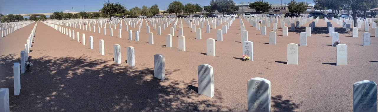 A panorama of a small section of Fort Bliss National Cemetery, showing the regular array of memorial markers