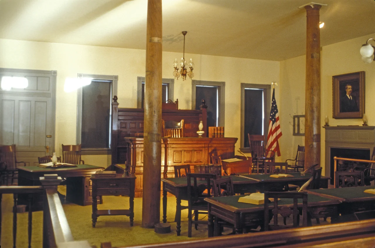 Judge Isaac Parker, the "Hanging Judge" HELD COURT HERE FOR 21 YEARS. HE WAS RESPONSIBLE FOR THE WESTERN HALF OF ARKANSAS AND THE INDIAN TERRITORY OF PRESENT-DAY OKLAHOMA. HE HELD 13,000 TRIALS IN THIS ROOM RESULTING IN CONVICTIONS OF 9,000. HE SENTENCED 160 TO DEATH BUT ONLY 79 WERE HANGED. NO APPEAL WAS POSSIBLE FOR THE FIRST 14 YEARS. HE BROUGHT LAW AND ORDER TO THE LAWLESS INDIAN TERRITORY.
THIS COURTROOM IS INSIDE THE BARRACKS BUILDING OF THE FORT SMITH NATIONAL HISTORIC SITE.