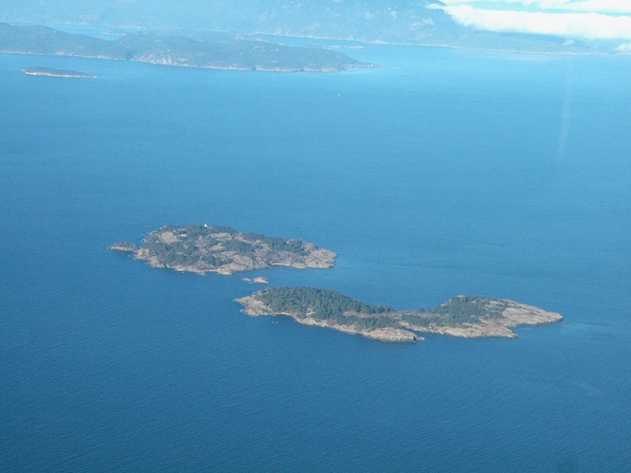 Aerial photograph I took myself of Ballenas Islands in the Strait of Georgia. Ballenas Light is on the top Island of the pair in the foreground.  You can then see Sangster, then Lasqueti and then Texada Islands in the background.  These islands are in the Straits of Georgia between Vancouver Island and mainland British Columbia, Canada.  This photo is taken facing North.