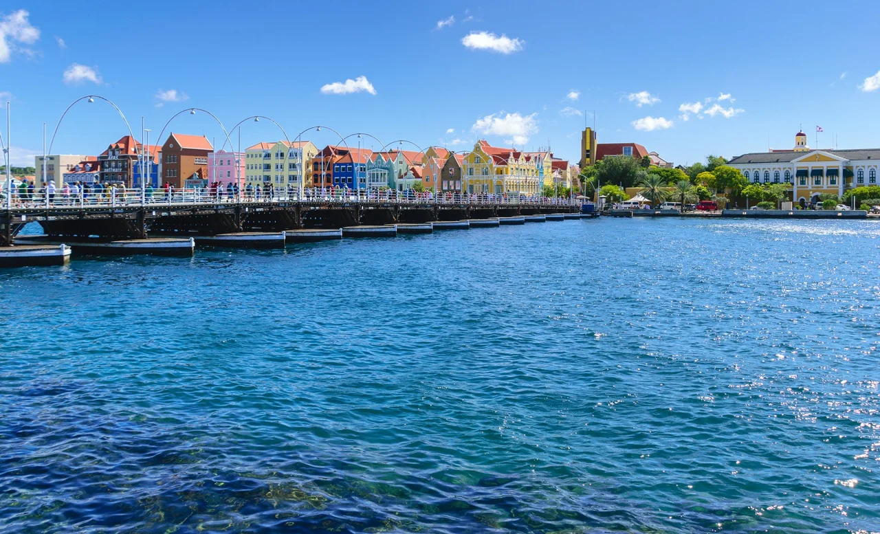 View of the district of Otrobanda, Willemstad, Curaçao, from Queen Emma Bridge, a pontoon bridge across St. Anna Bay. It connects the Punda and Otrobanda quarters of the island's capital. The bridge is hinged and opens regularly to enable the passage of oceangoing vessels.
