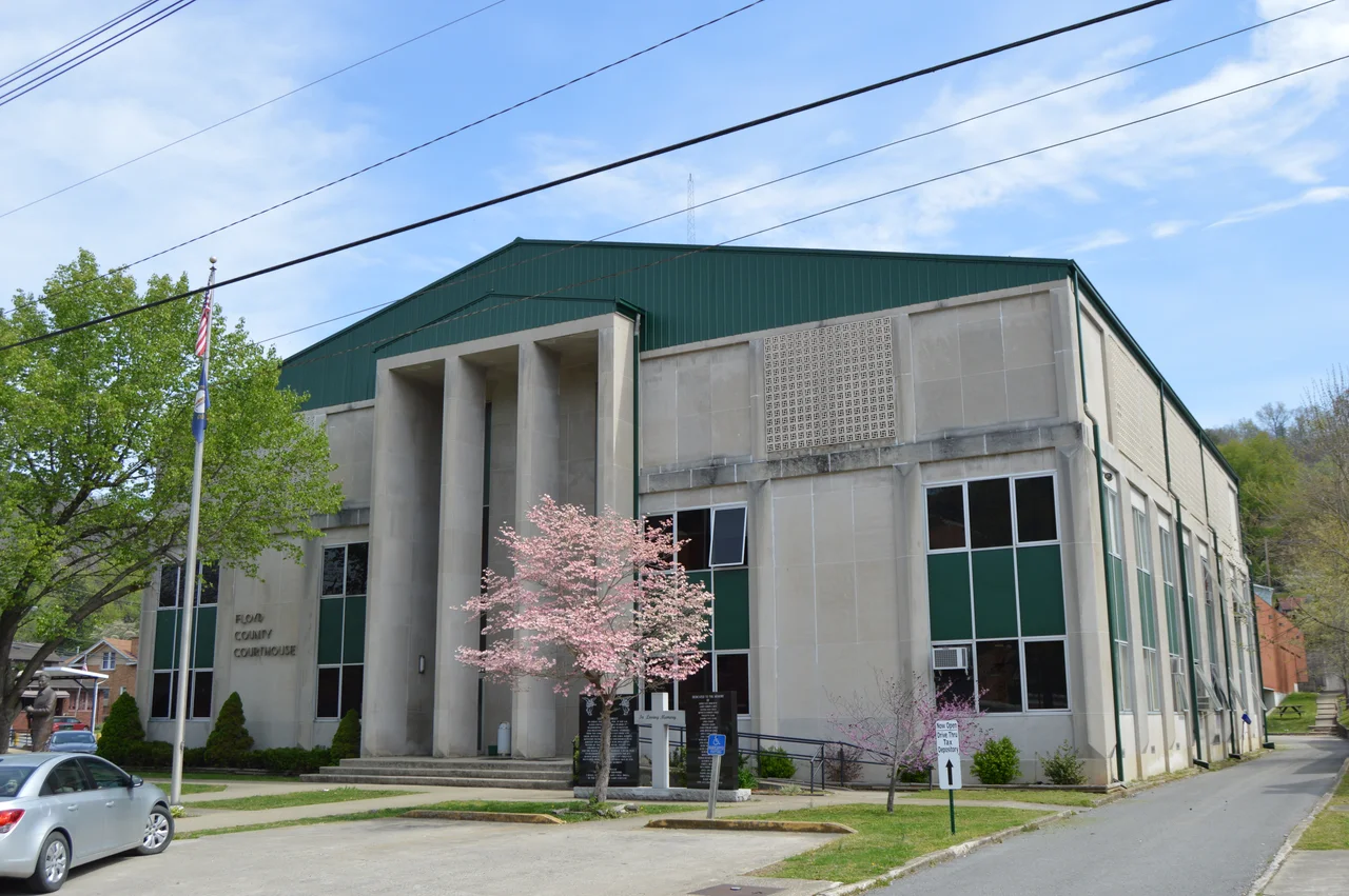 Front and southern side of the former Floyd County Courthouse, located on Third Avenue in downtown Prestonsburg, Kentucky, United States.  It was built in 1964.  The cross and black stone markers in front of the courthouse are a memorial to the victims of the Prestonsburg bus disaster of 1958.