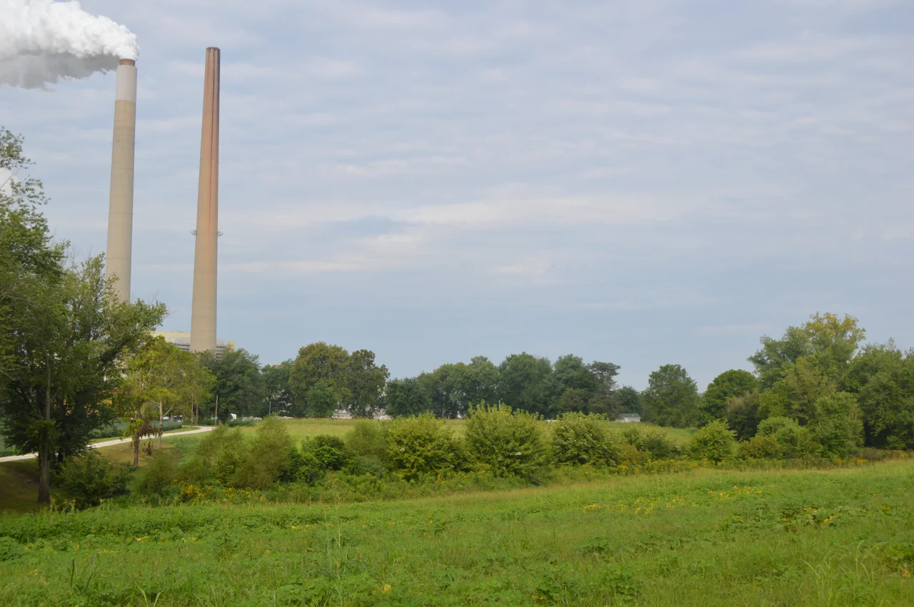 Fields on the western side of State Route 681 just northwest of Darwin in Sutton Township, Meigs County, Ohio, United States.  In the background are the chimneys of the AEP Mountaineer Power Plant in Mason County, West Virginia.