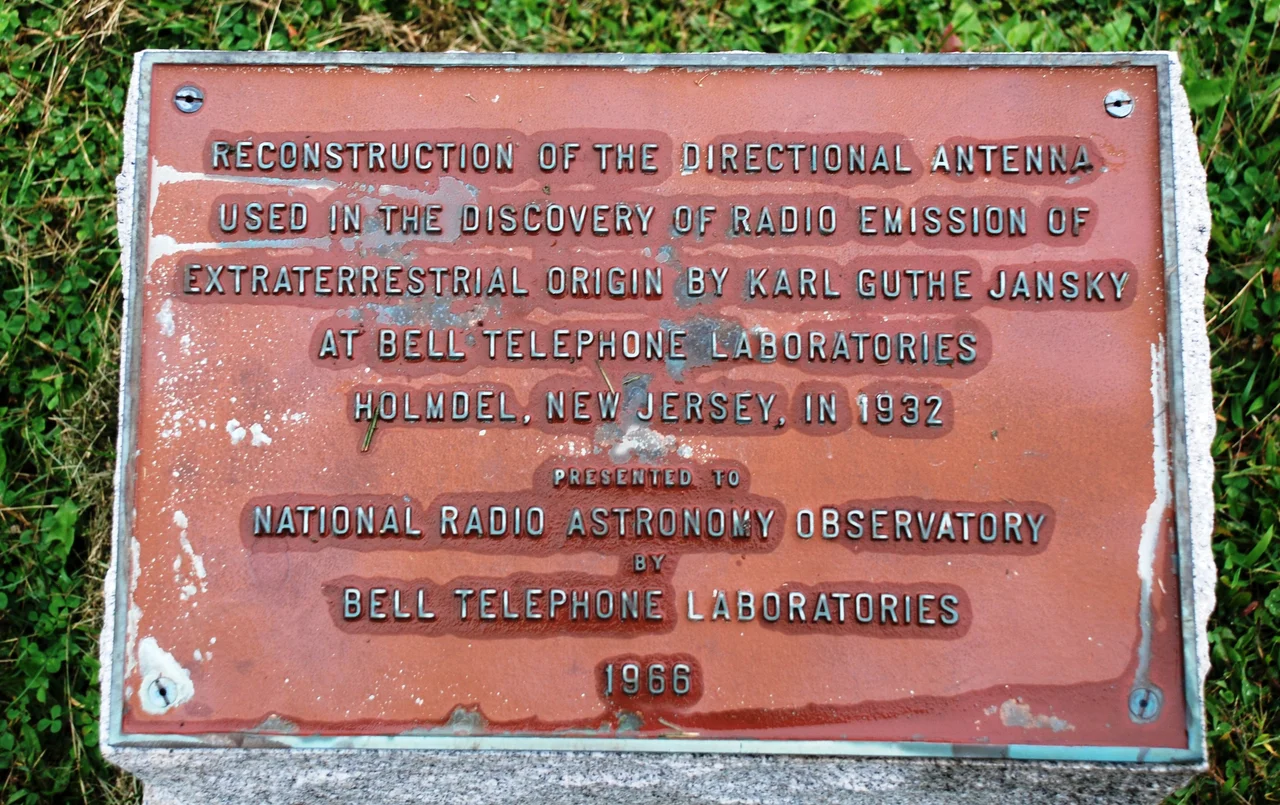 Plaque next to full-size replica of the first radio telescope, built by Karl Jansky and now at National Radio Astronomy Observatory in Green Bank, West Virginia. Text of the  plaque: "Reconstruction of the directional antenna used in the discovery of Radio emission of extraterrestrial origin by Karl Guthe Jansky at Bell Telephone Laboratories Holmdel, New Jersy, in 1932. Presented to National Radio Astronomy Observatory by Bell Telephone Laboratories 1966".