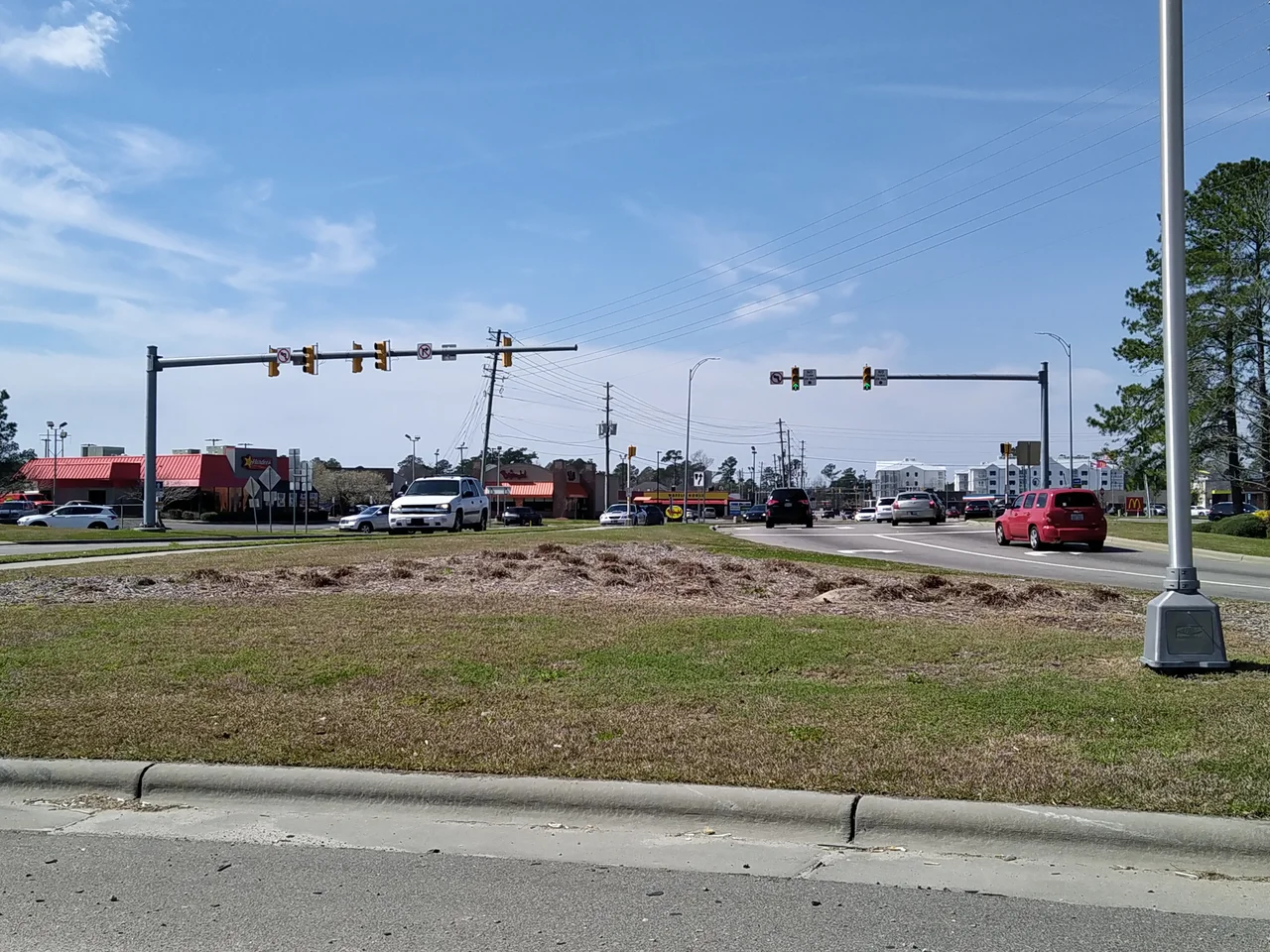 Village Road in the southeastern portion of Leland, North Carolina, showing the southern end of a major commercial strip,  This was taken from the westbound off-ramp of US Routes 17, 74 and 76, where NC 133 departs those routes to head south towards the access routes to Oak Island and Southport.  While not easily discernable from this view, this is a diverging diamond interchange.