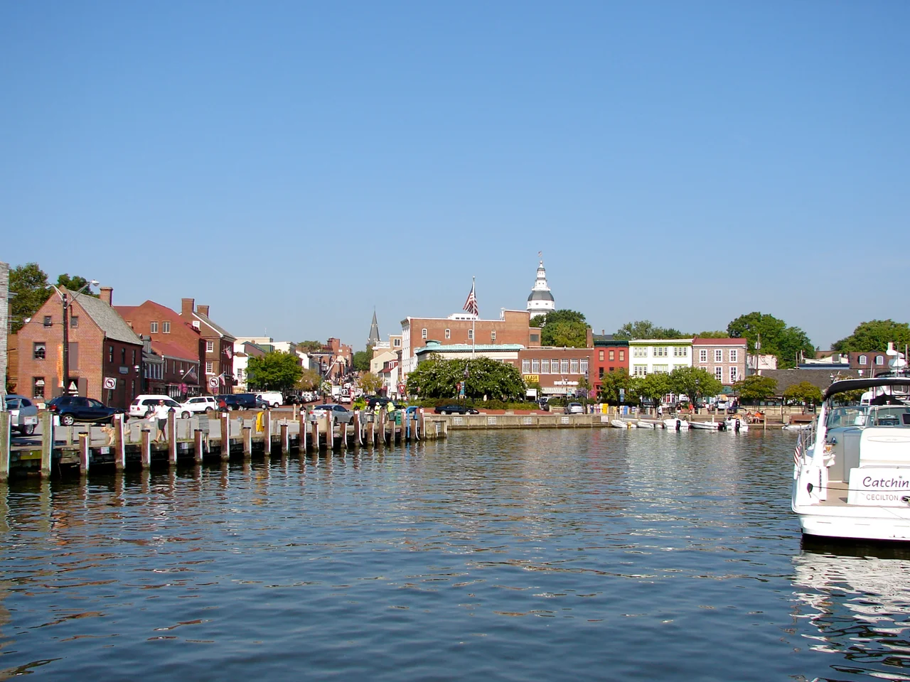 The dock or harbor in Annapolis, Maryland.  Dock Street is just out of the frame of the photo to the right.  Folks leaving their boats tied up here would step right out into the street.  The Maryland State Capitol is the tall tower in the distance.  At the end of the street/harbor is a set of statues showing Alex Haley (author) reading to children.  His ancestor Kunte Kinte landed in the harbor as a slave coming from Africa, according to Haley (and historical markers near the statues).