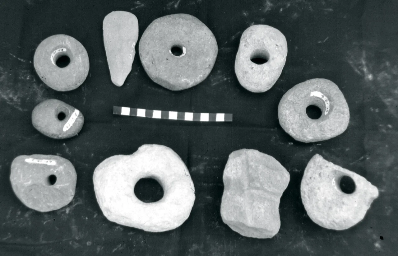 Photo taken in 1968 at the Sierra Leone Museum, Freetown. Scale in centimetres.
From ethnographic analogy, these were probably used as digging stick weights, possibly in mining activities.
Short discussions of bored stones in West Africa can be found in the following:
R. Schnell, PLANTES ALIMENTAIRES ET VIE AGRICOLE DE L'AFRIQUE NOIRE: Essai de phytogógraphie alimentaire, pp. 45-46. (Larose, Paris, 1957) There is even a photograph of them being used (opposite page 176).

Oliver Davies, THE QUATERNARY IN THE COASTLANDS OF GUINEA (Glasgow, 1964), pp. 196 -199.
Oliver Davies, WEST AFRICA BEFORE THE EUROPEANS (London, 1967), p. 203

John H. Atherton, "Speculations on Functions of Some Prehistoric Archaeological Materials from Sierra Leone," In B. K. Swartz, Jr. and Raymond A Dumett, editors, WEST AFRICAN CULTURAL DYNAMICS (The Hague, 1980), pp. 266 - 270)