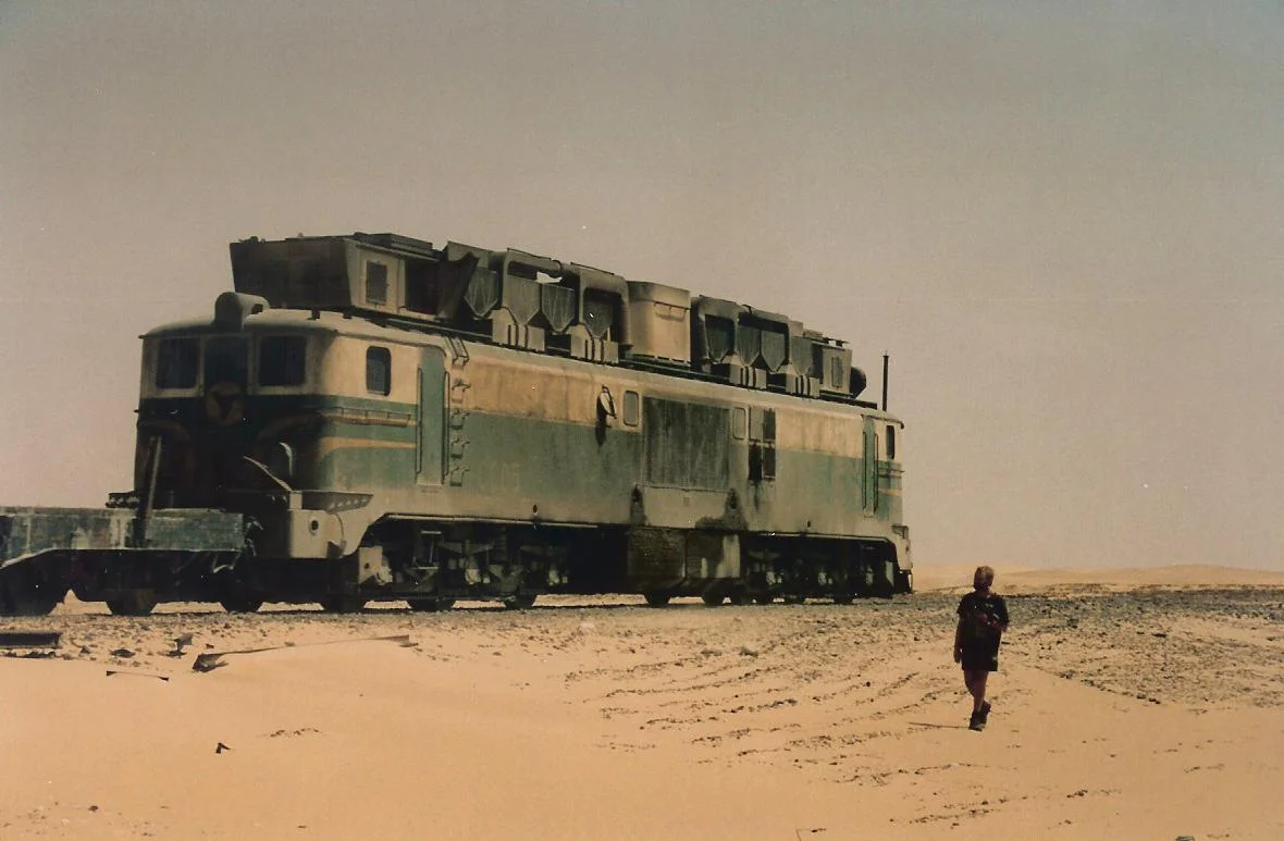 SNIM Alsthom locomotive no CC05, on the Mauritania Railway between Nouadhibou and Zouerate, northern Mauritania.  The "skyline casing" on the locomotive's roof houses special filtration equipment, to deal with the sandy and dusty Saharan atmospheric conditions evident in this photo.