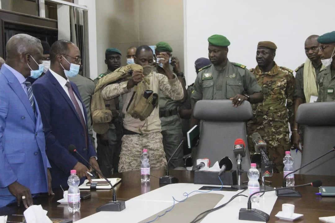 Assimi Goïta, surrounded by members of the National Committee for the Salvation of the People, about to do a press conference where he proclaims himself head of the ruling junta in Mali, after the coup d'État.