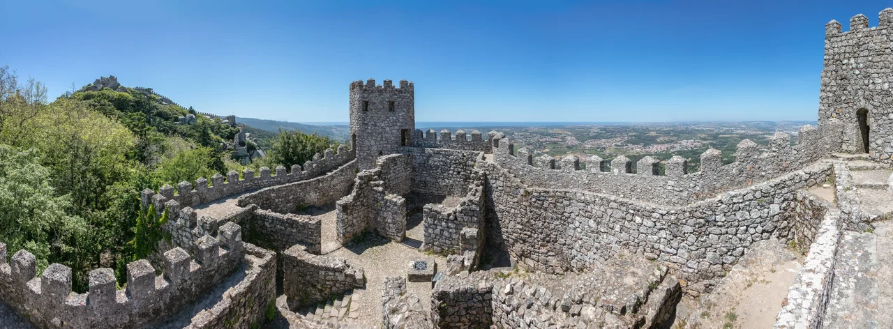 Panoramic view of the interior of the castle of the Moors, a hilltop medieval castle located in the municipality of Sintra, about 25 kilometres (16 mi) northwest of Lisbon. Built by the Moors in the 8th and 9th centuries, the UNESCO World Heritage Site was an important strategic point during the Reconquista, and was taken by Christian forces after the fall of Lisbon in 1147.