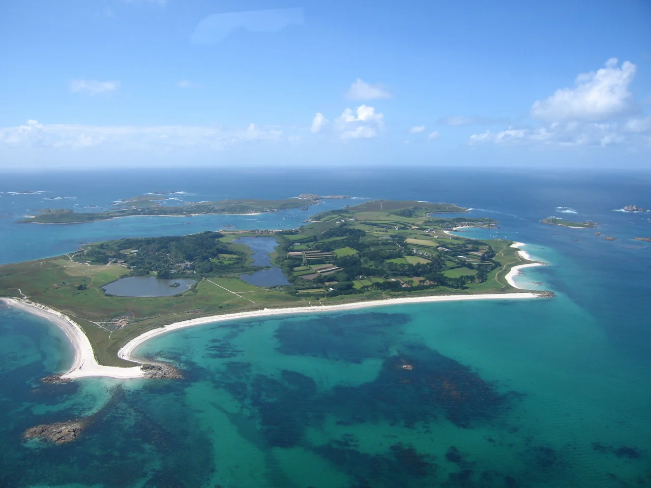 Looking across Tresco, one of the five inhabited islands of the Isles of Scilly 45 km (28 miles) from the coast of Cornwall in the United Kingdom. Photo taken from a helicopter using a Canon PowerShot S70 camera in June 2005.