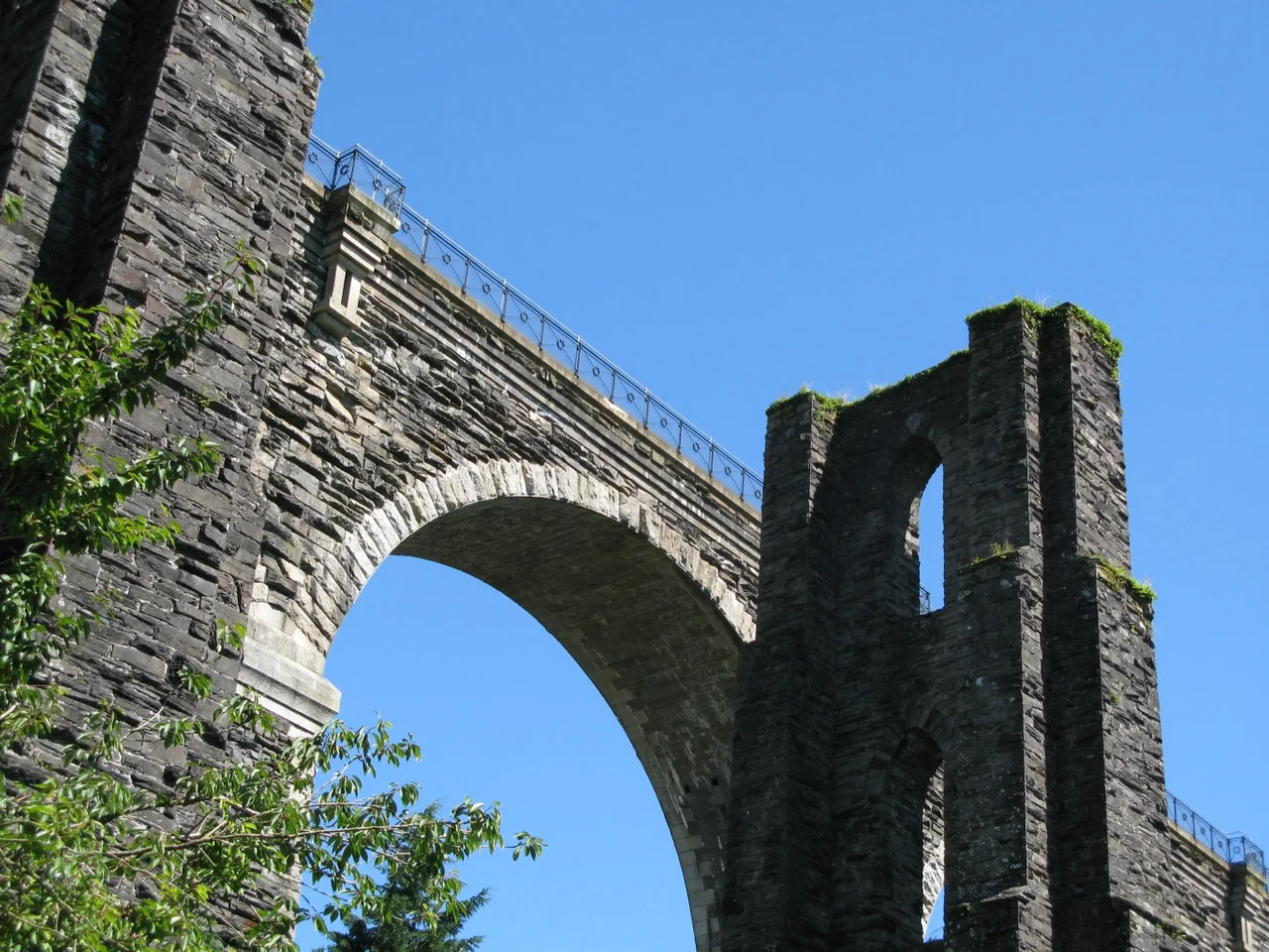 A pier of Isambard Kingdom Brunel's original viaduct stands alongside the replacement Moorswater Viaduct at Liskeard, Cornwall, United Kingdom.