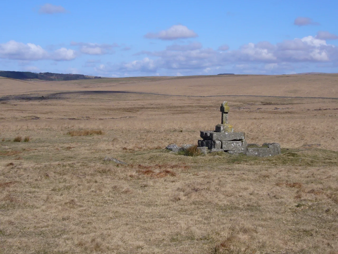 Looking East & showing the setting of Childe's Tomb located on the south-east edge of Foxtor Mire on Dartmoor at grid reference SX625704. Legend has it that the cross was erected over the kistvaen (burial chamber) of Childe the Hunter.