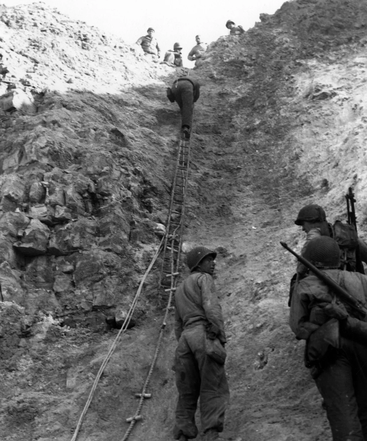 Normandy Invasion, June 1944 U.S. Army Rangers show off the ladders they used to storm the cliffs at Pointe du Hoc, which they assaulted in support of "Omaha" Beach landings on "D-Day". Removed caption read: Photo #80-G-45716 Army Rangers at Pointe du Hoc, 6 June 1944