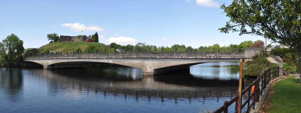 This is a photo of the bridge in Belleek, County Fermanagh, Northern Ireland. Taken from the northern border side within the grounds of the belleek pottery factory. Belleek fort is also visible in this photograph.