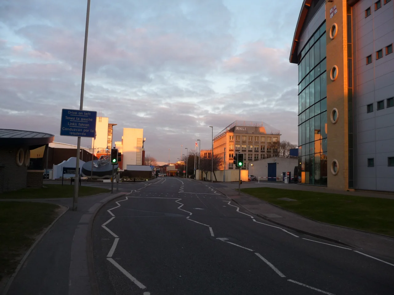Poole : West Quay Road West Quay Road with several RNLI buildings surrounding it, and a sign which reminds us to drive on the left side of the road.
