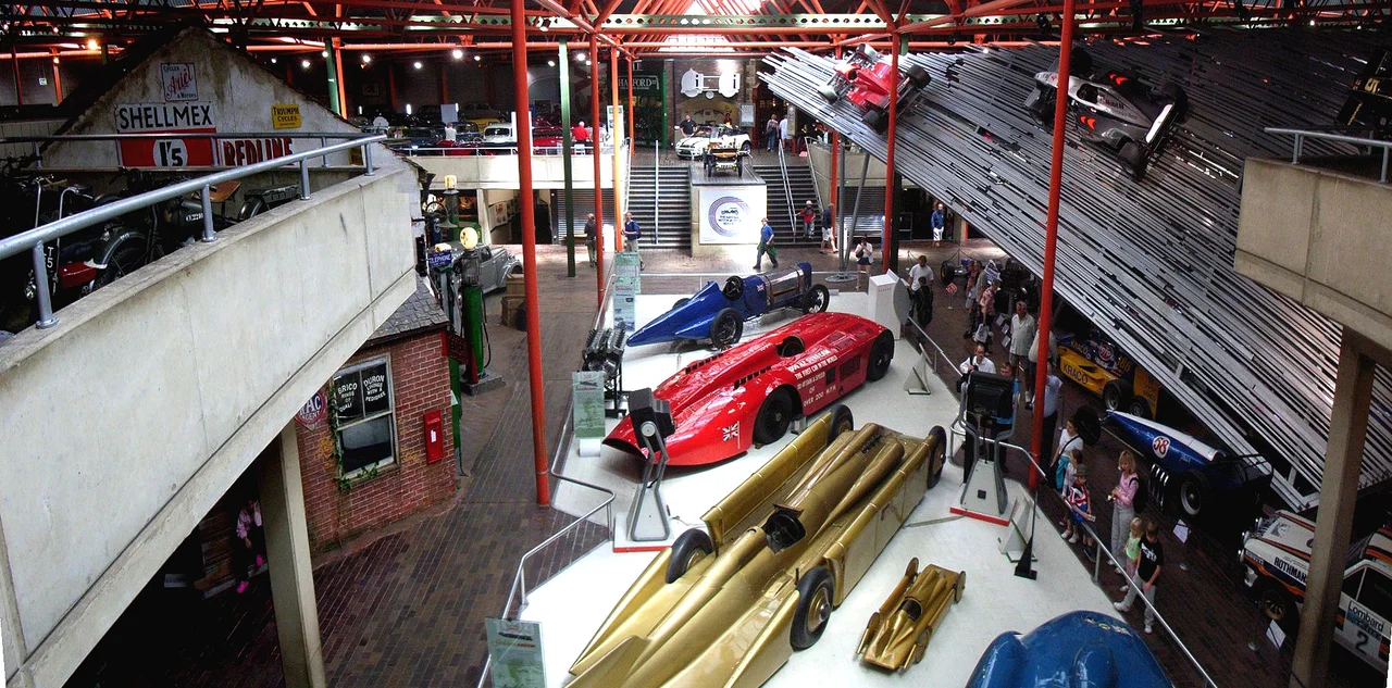 National Motor Museum in Beaulieu, panorama of main hall. Low center is Golden Arrow, above in red is Sunbeam 1000 hp, above is Cambells Blue Bird