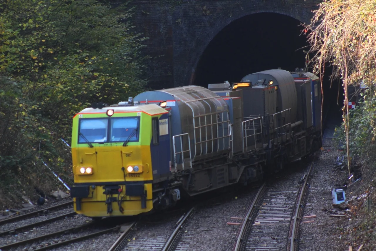 Network Rail's Multi-Purpose Vehicles 98922 and 98972 emerge from Fisherton Tunnel and take the Romsey route. They are working as a Rail Head Treatment Train at a spot where low rail adhesion on the London route to the right is thought to be the cause of a recent train collision.
