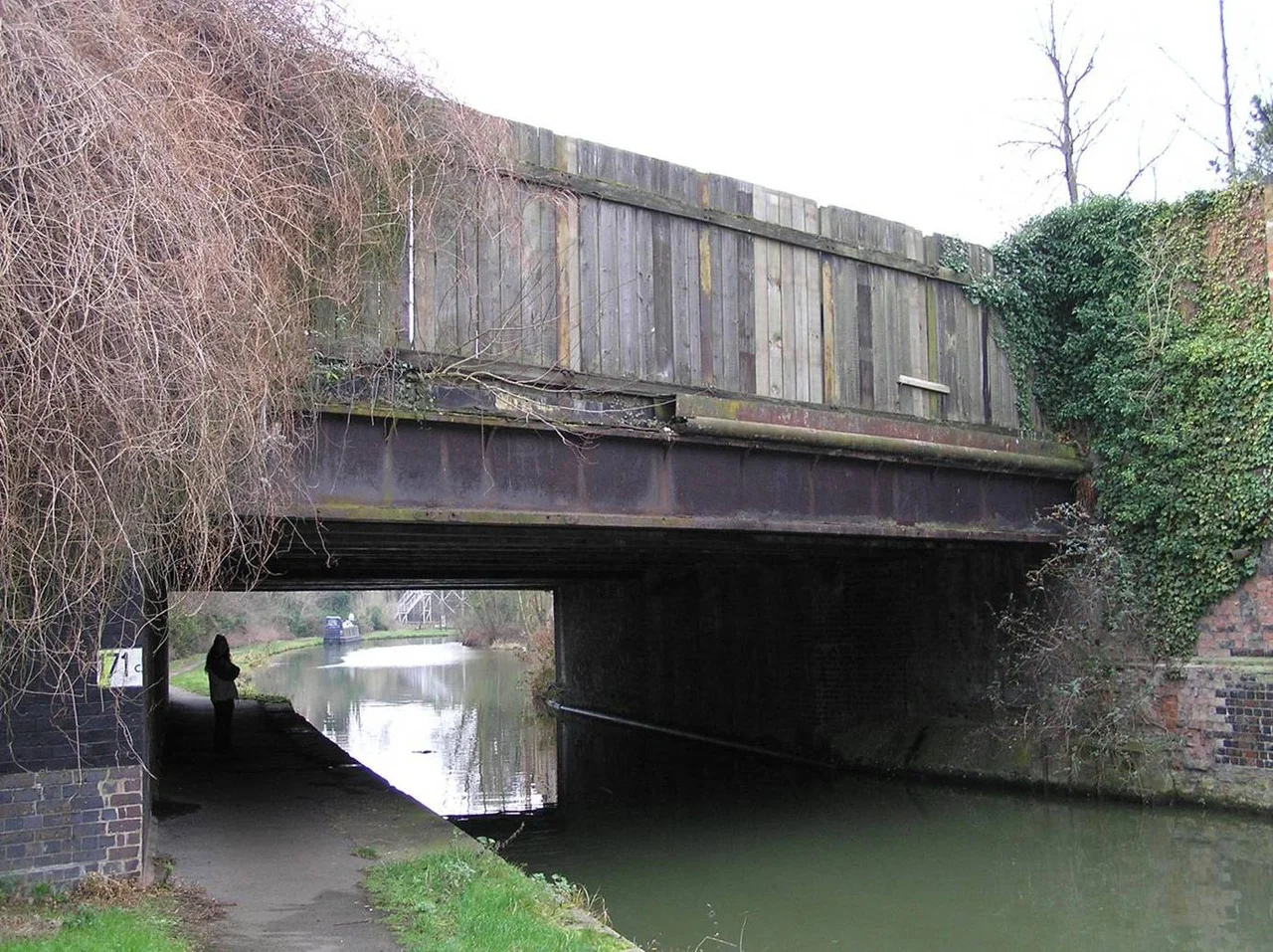 Cast iron girder bridge carrying the West Coast Main Line over the Grand Union Canal in Wolverton, Buckinghamshire. Designed and built for the London and Birmingham Railway in 183435 when Robert Stephenson was chief engineer.