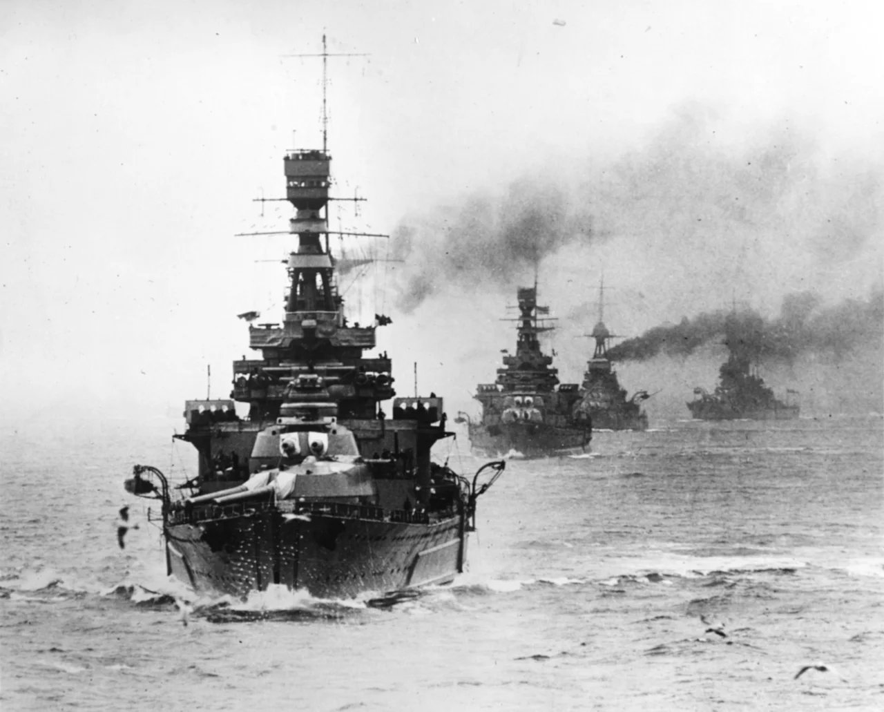The battlecruiser HMS Repulse leading other Royal Navy capital ships during maneuvers, circa the late 1920s.

The next ship astern is HMS Renown. The extensive external side armor of Repulse and the larger "bulge" of Renown allow these ships to be readily differentiated.