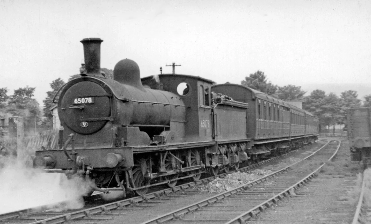 Last Train waiting to leave Wearhead for Bishop Auckland.
View NW, towards buffer-stops; ex-NE terminus of line from Bishop Auckland, 27/6/53: the locomotive is ex-NE J21 No. 65078. Goods traffic continued up the valley as far as St John's Chapel until 2/1/61; a passenger service, Bishop Auckland - Stanhope was restored by the Weardale Railway from 23/5/10. See also 2047797 and NZ2029 : The Last Train to Wearhead waits to leave Bishop Auckland Station.