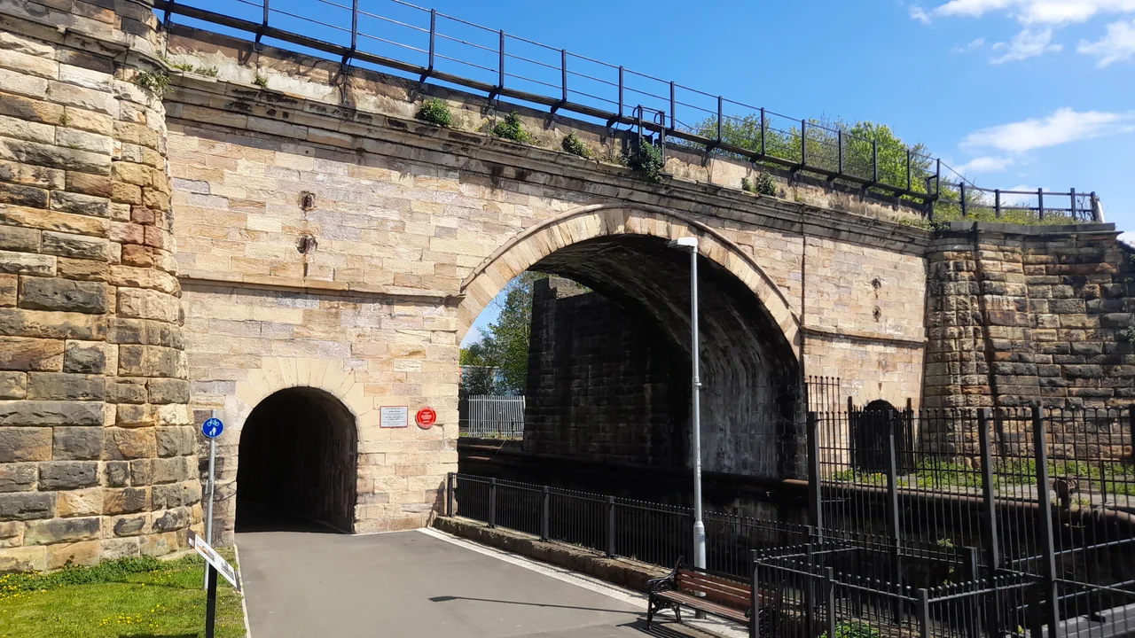 Railway bridge over the River Skerne in Darlington, UK. The oldest railway bridge in continuous use in the world. The centre section is the original stone arch built for the Stockton and Darlington Railway in 1825; the curved flanking walls were added later to strengthen it. The bridge was also widened on the north side; this was later removed, leaving only the piers beside the original bridge.