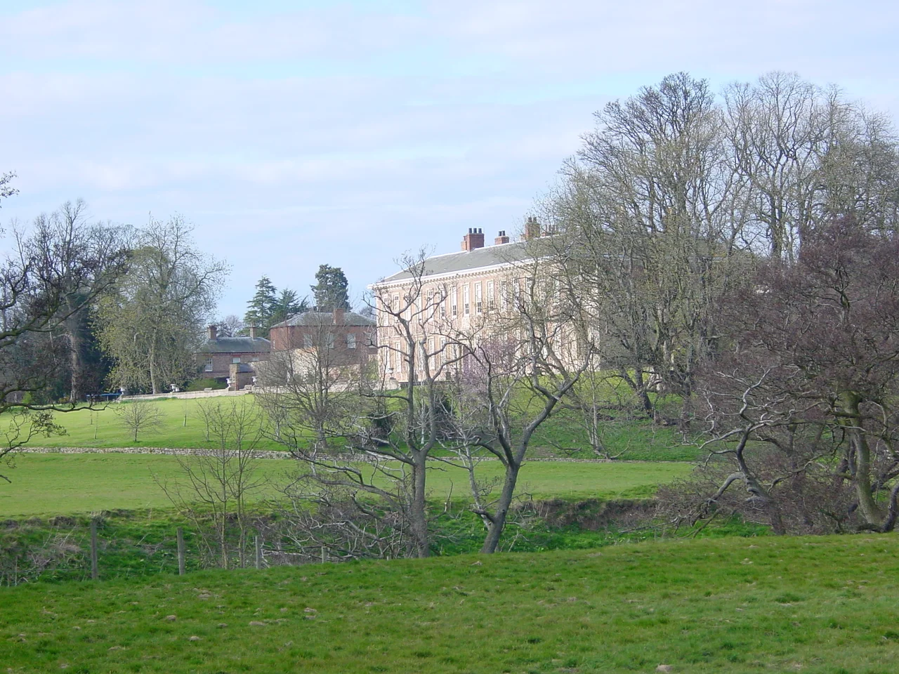 Looking over the River Nidd at the front of Ribston Hall, Great Ribston, near Knaresborough, North Yorkshire, England, UK.