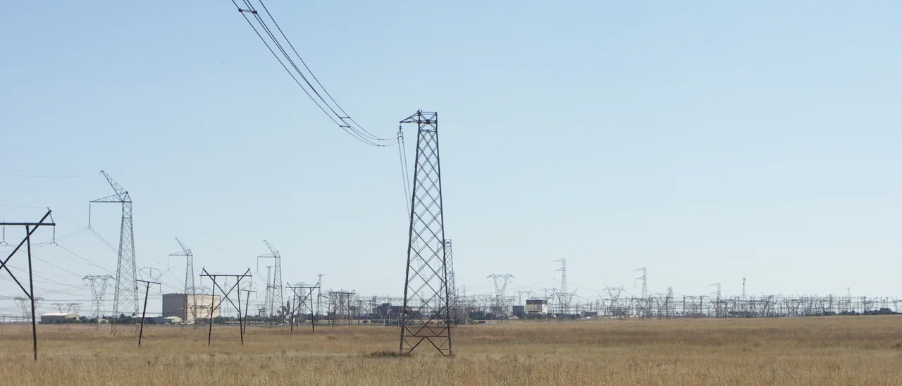 The Apollo HVDC converter station and HVDC and HVAC distribution cables running to it. Photo taken from within Rietvlei Nature Reserve, South Africa.
Tall pylons on the left are part of the Cahora Bassa HVDC line.