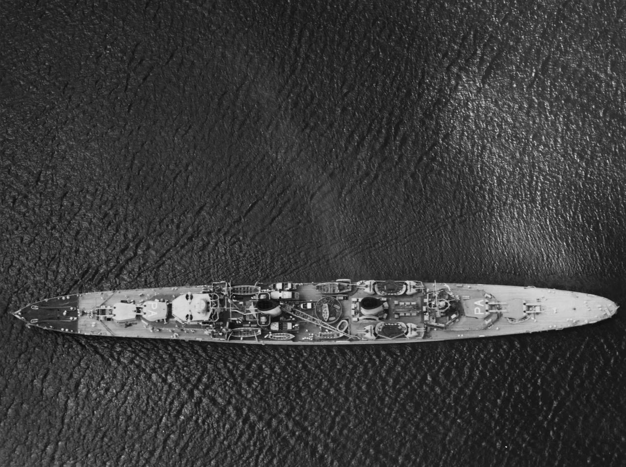 The Royal Australian Navy light cruiser HMAS Perth (D29) in Gatun Lake, Panama Canal, 2 March 1940. Note the aircraft identification symbols on the turret tops.
