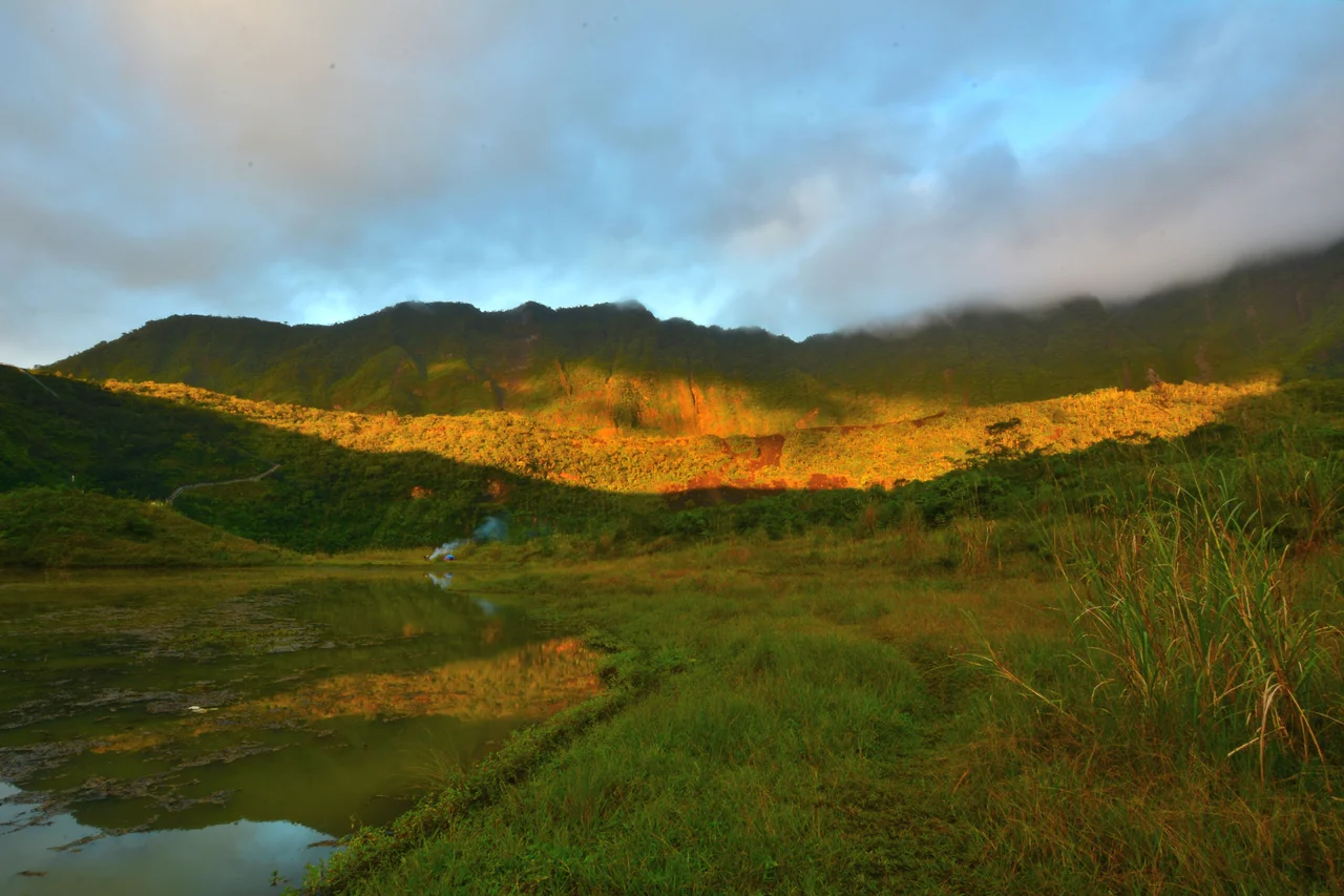 The sun shines through some part of Galunggung mountain in the early morning