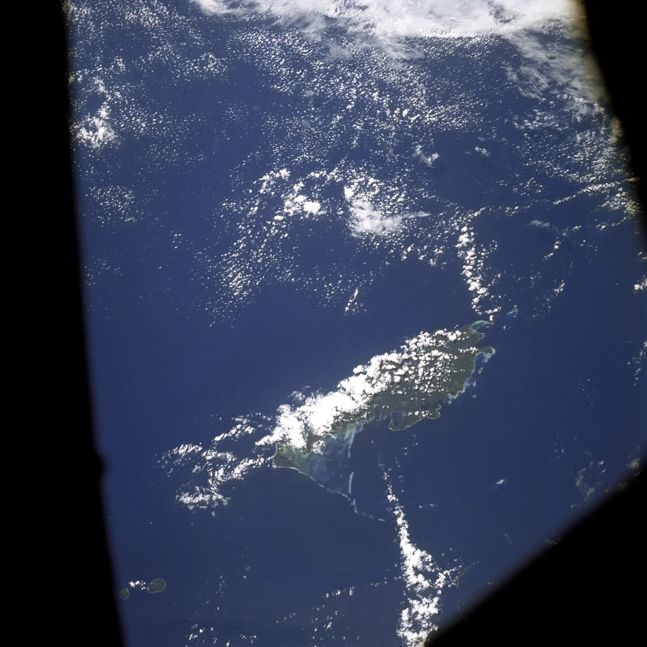 AS07-04-1609 (21 Oct. 1968) --- Woodlark Island in the Solomon Sea, east of New Guinea and northeast of Australia, as seen from the Apollo 7 spacecraft during its 158th revolution of Earth. Photographed from an altitude of 140 nautical miles, at ground elapsed time of 251 hours and 21 minutes.