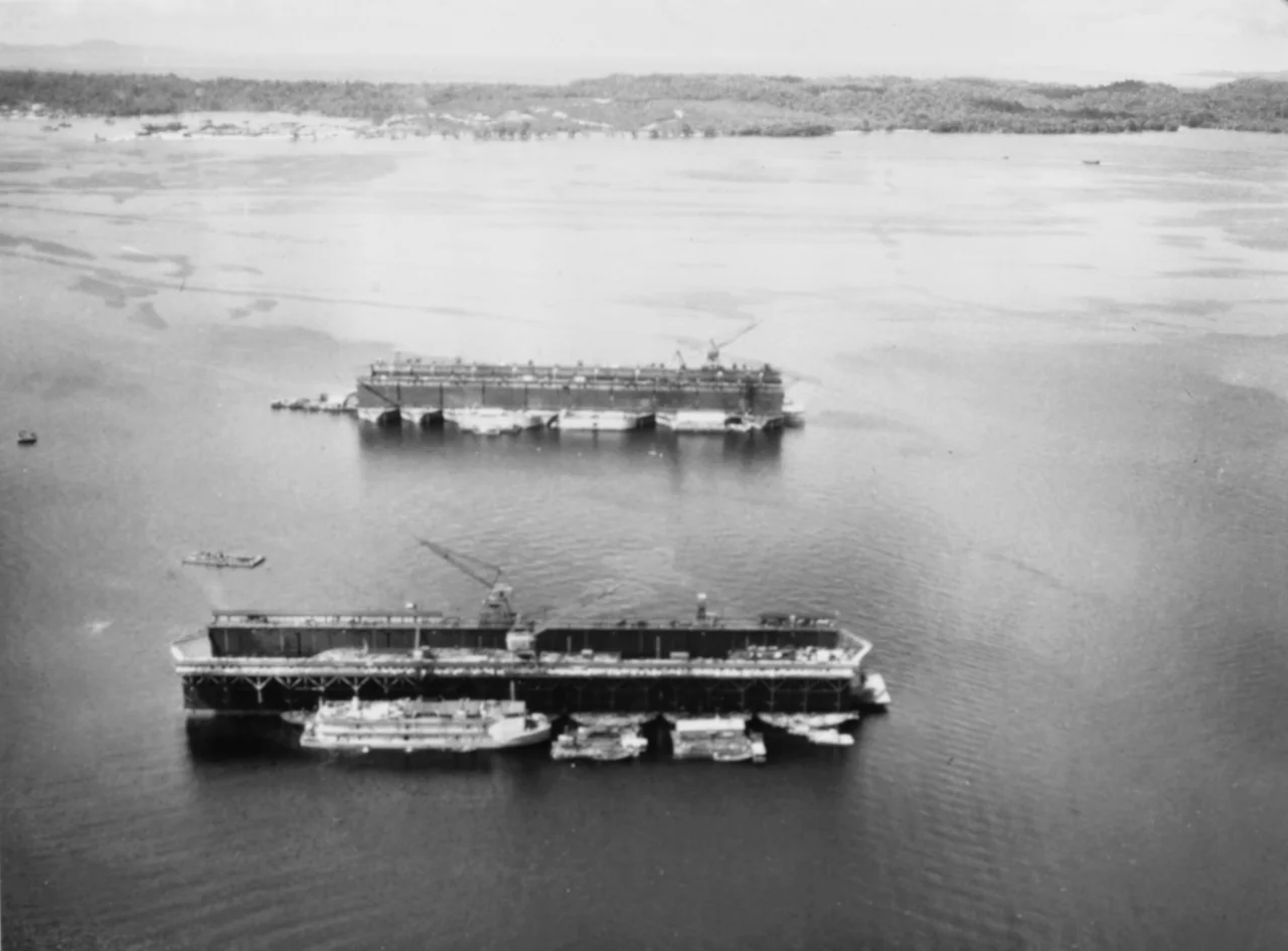 The U.S. Naval Amphibious Base, Manus, Admiralty Islands: Floating drydocks ABSD-2 (foreground) and ABSD-4 in Seeadler Harbor, Manus, 18 September 1945.