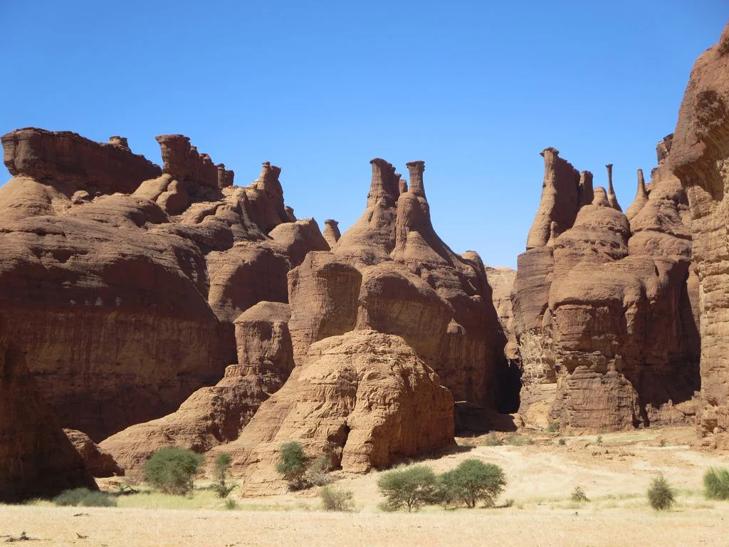These hoodoos overlook Elephant Rock in the Tokou East area of the Ennedi Mountains, Chad, Central Africa.