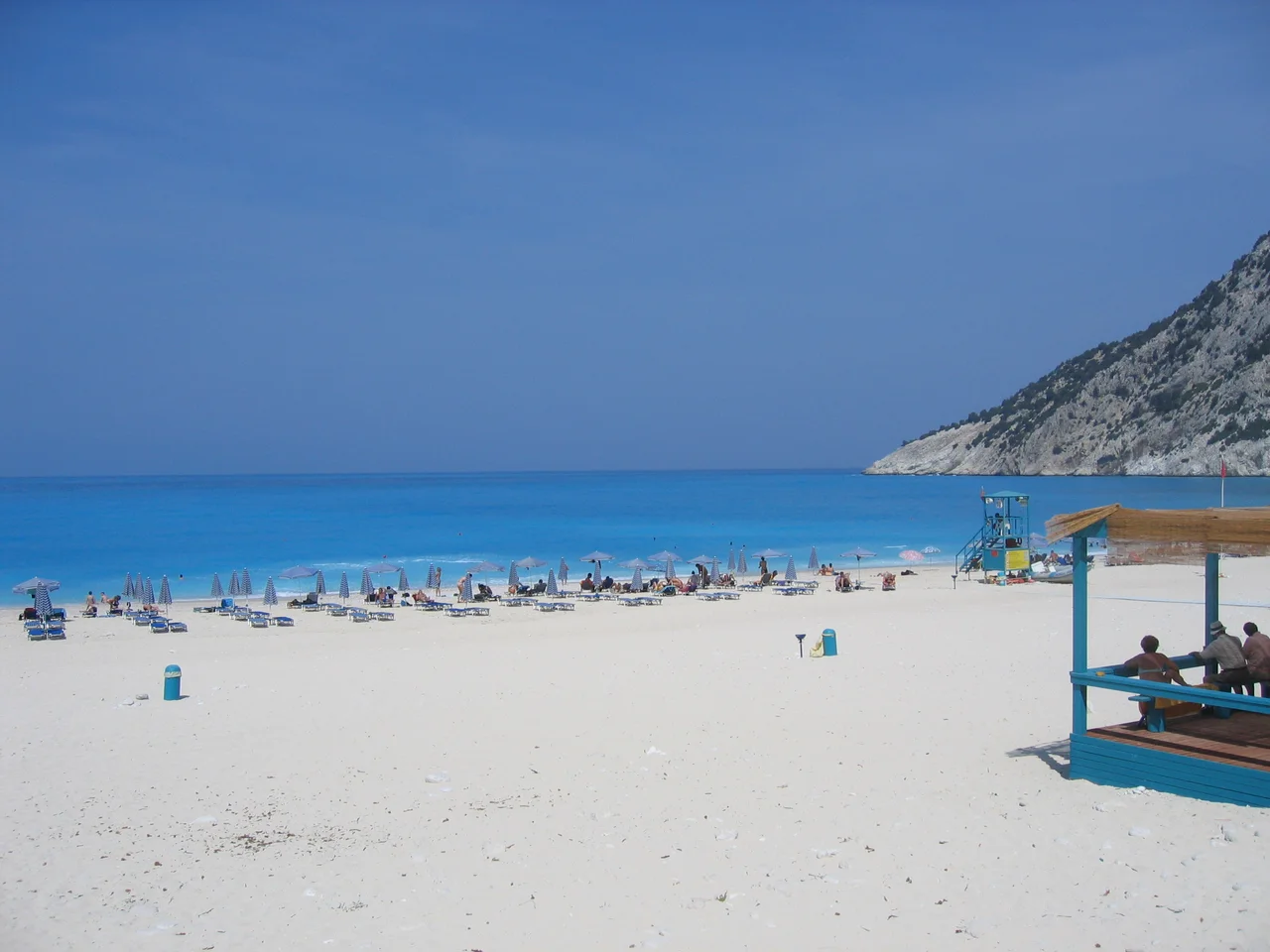 Myrtos Beach, Kefalonia. Greece. The beach is made of white marble pebbles and has a small taverna. The sea is bright turquoise in colour
