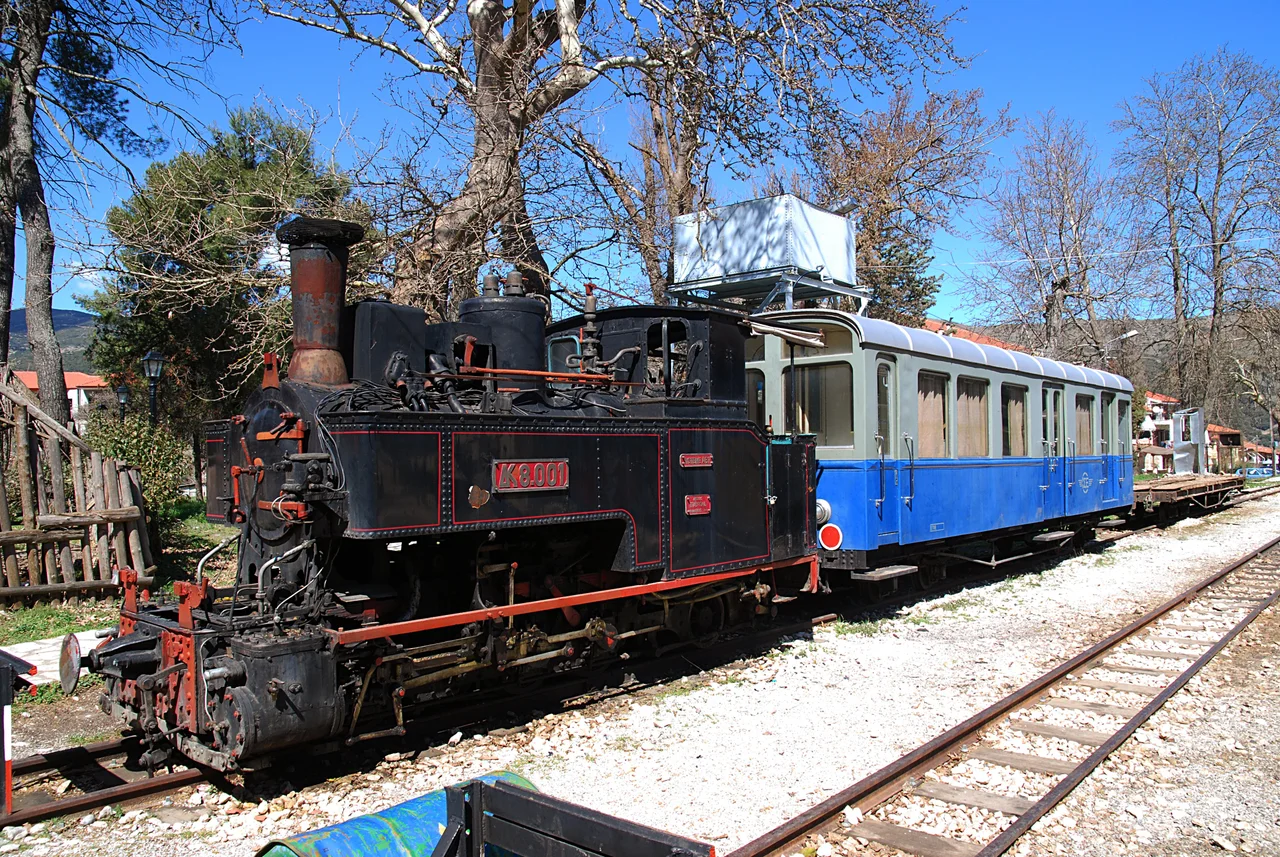 GREECE: Cail narrow gauge (750 mm) steam locomotive ΔΚ-8001 and observation car ΑΒ ΔΚ-121 of the Diakofto-Kalavryta rack railway.