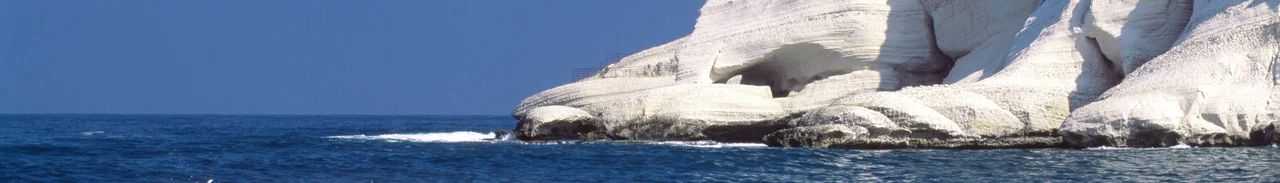 Rosh HaNikra is a geologic formation in Israel, located on the coast of the Mediterranean Sea, in the Western Galilee. It is a white chalk cliff face which opens up into spectacular grottoes. The picture shows the cliff and the grottoes from the shore.Photo taken by Itamar Grinberg for the Israeli Ministry of Tourism. Credit attribution requested.