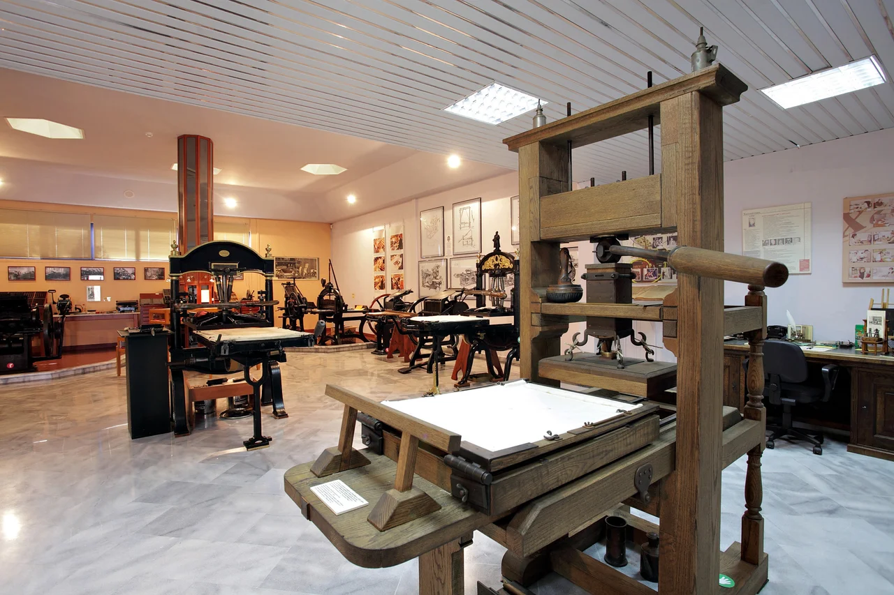 Cast iron printing presses from the 19th century and a replica of a wooden press from the days of Gutenberg welcome the visitors of the Museum of Typography.