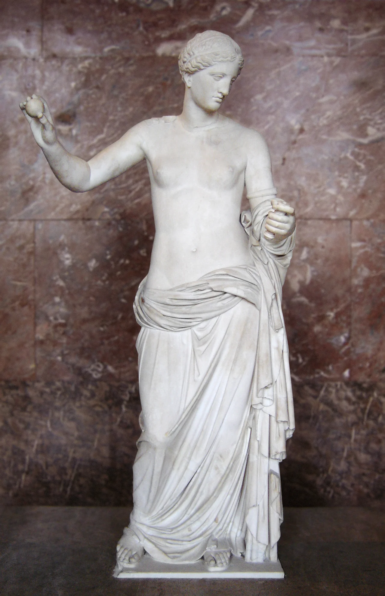 Statue of Aphrodite, known as the Venus of Arles. Hymettus marble, Roman artwork, imperial period (end of the 1st century BC), might be a copy of the Aphrodite of Thespiae by Praxiteles. The apple and the mirror were added during the 17th century. Found in the ancient theatre of Arles, France.