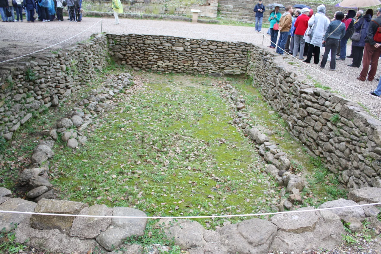 Prehistoric building in northern Olympia, Greece.  According to nearby signs, Wilhelm Dörpfeld and Fritz Weege discovered this and other houses in 1908.  They date to the late Early Helladic III period or later, 2150-2000 BC.