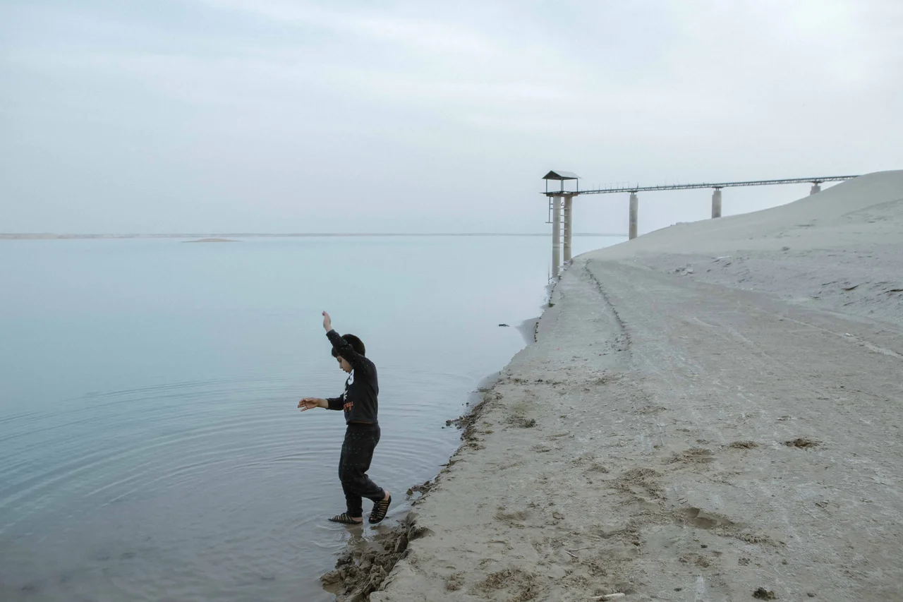 Children are playing around the Chah Nimeh reservoirs. The Chah Nimeh reservoirs are large natural holes in Sistan province into which Hirmand river water is directed. In times of water shortage, Sistan’s drinking water and some part of its farming water are provided through this artificial lake. The only sign of water in the Sistan landscape is the Chah Nimeh reservoir.
During 20 years, the Hamoun wetlands had vanished after the South Asia region was hit by the most persistent drought. Besides building many dams at the Upstream Hirmand, Afghanistan refuses to adapt to Iran’s water rights and violates its water agreements. Sistan province.2018