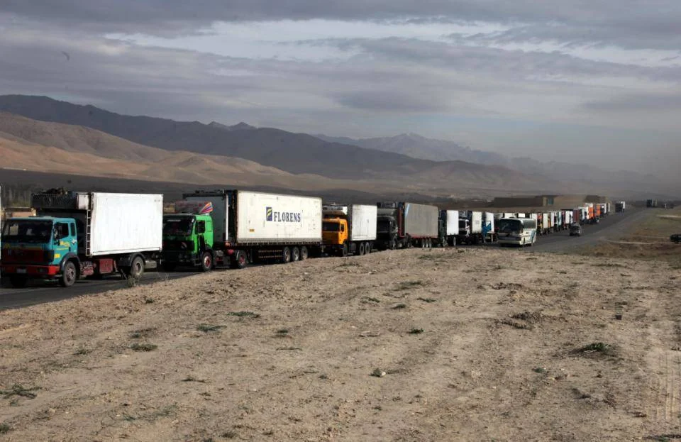 A convoy of trucks driven by Afghans wait patiently on highway 1 for elements of the U.S. military to clear the dangerous stretch of road ahead of any possible Imrovised Explosive Devices and enemy fighters in Sayed-Abad District, Wardak Province, Afghanistan, 28 March 2010. (U.S. Army photo by Sgt Russell Gilchrest\Released)