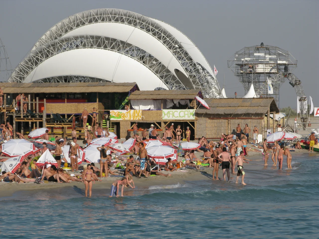 Kazantip Festival in Crimea in the 2000s: sun, sea, sandy beaches, parties, partygoers, celebrations, days, nights, DJs, serotonin, dopamine, trance, house and techno music.