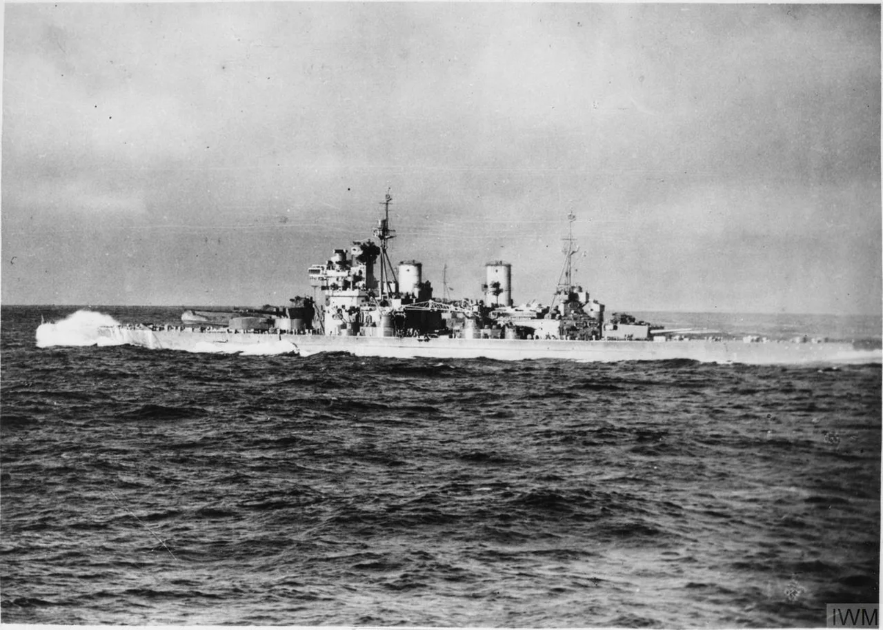 Waves crashing over the bow, HMS Duke of York steaming at 20 to 25 knots during an Arctic convoy to Russia (photographed from the aircraft carrier HMS Victorious).