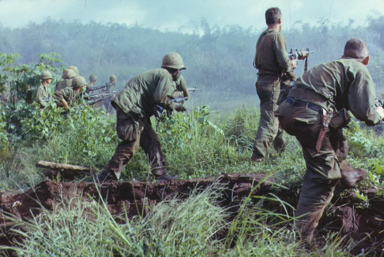 Dak To, South Vietnam. An infantry patrol moves up to assault the last Viet Cong position after an attempted overrun of the artillery position by the Viet Cong during Operation Hawthorne.